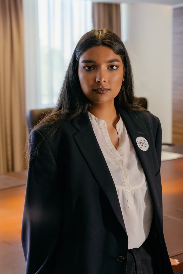 Portrait of a professional woman in corporate attire showcasing leadership and empowerment in office setting.